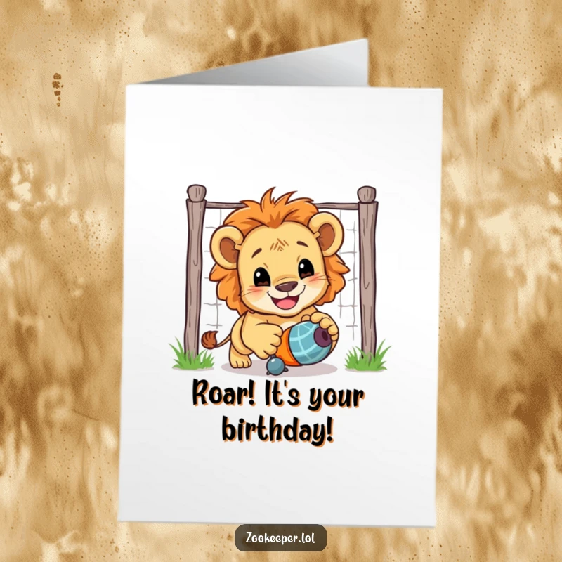 Funny free printable birthday card: A smiling lion cub playfully chases a toy, embodying energetic birthday excitement and fun.